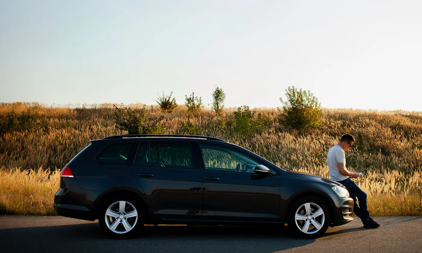 man-sitting-car-hood-1 man-sitting-car-hood-1